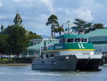 A photo of the R/V North Wind docked in front of the Humboldt Bay Aquatic Center with the Carson Mansion in the background.